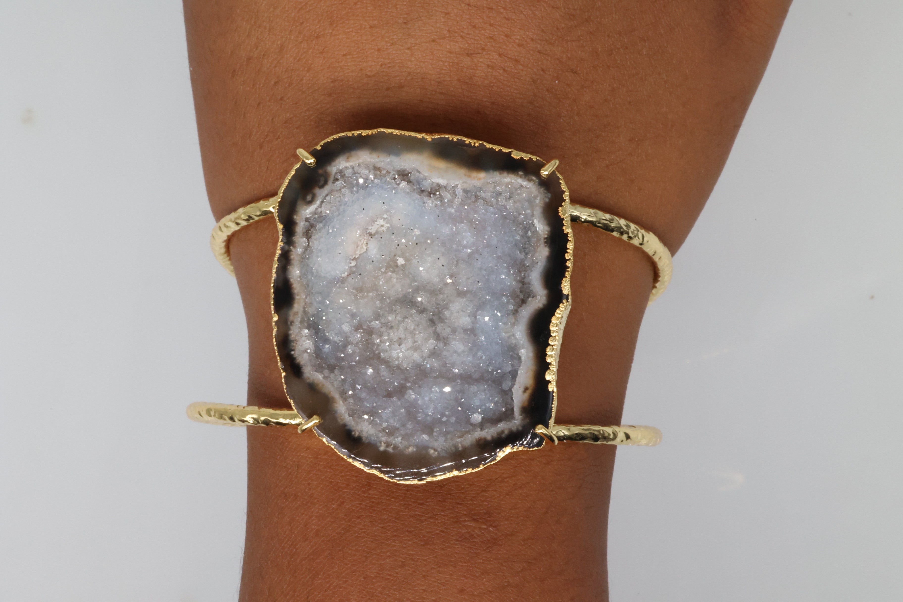Raw crystal geode cuff bracelet with textured gold band.