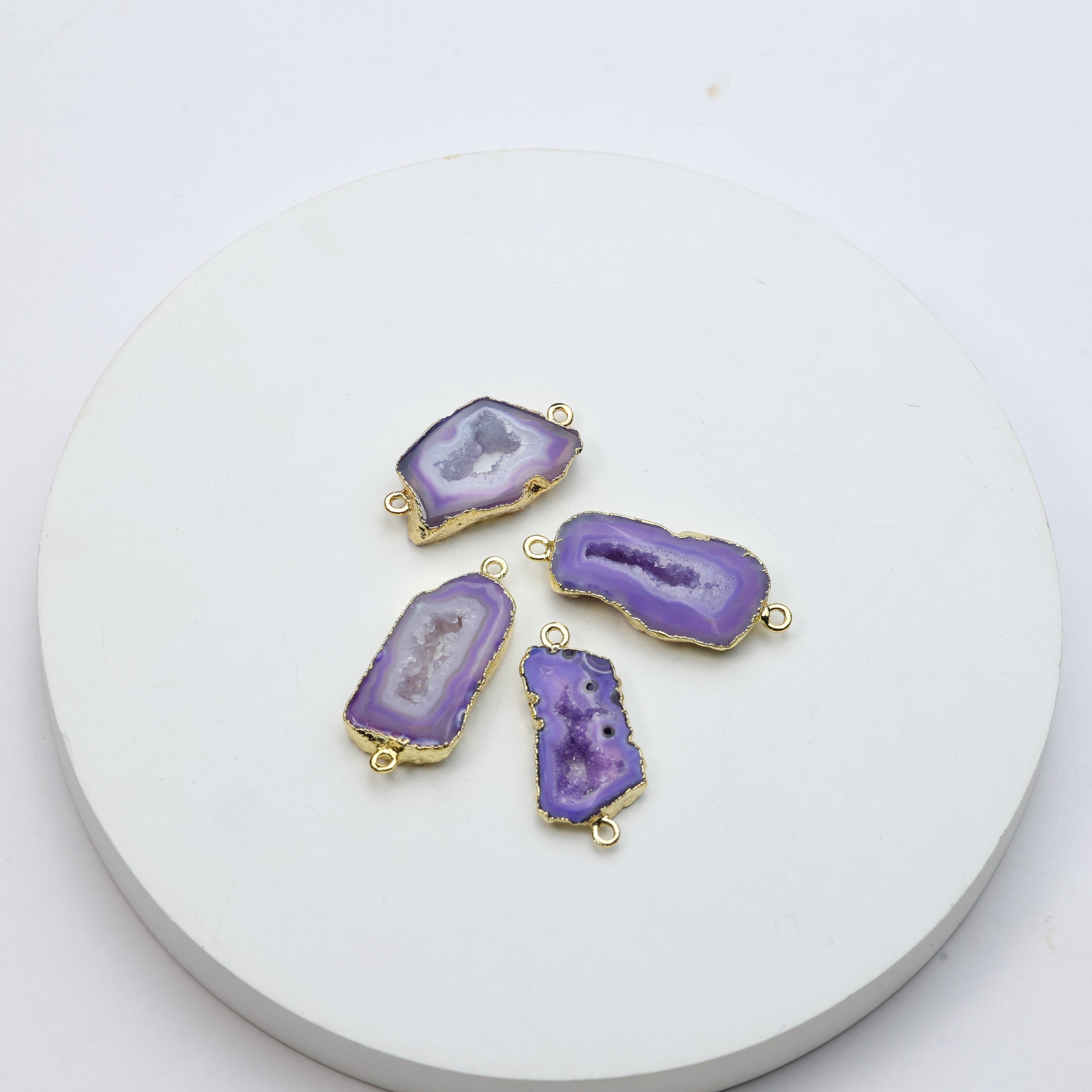 Purple druzy geode gemstone connectors featuring crystal interiors and gold edging
