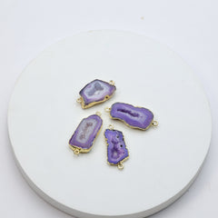 Purple druzy geode gemstone connectors featuring crystal interiors and gold edging