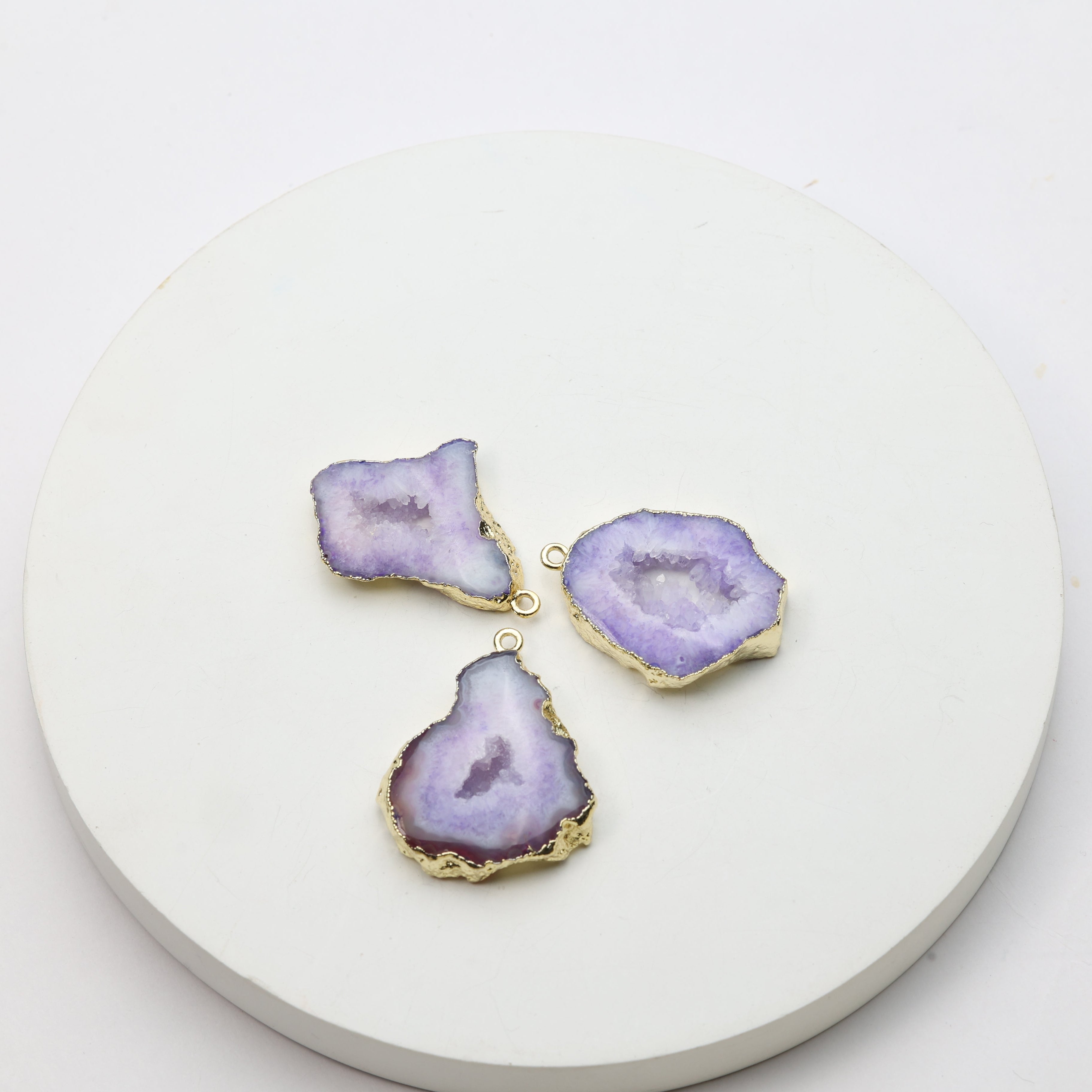 Purple geode slice pendants with sparkling druzy centers and gold connector loops