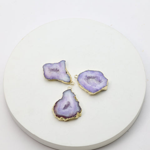 Purple geode slice pendants with sparkling druzy centers and gold connector loops