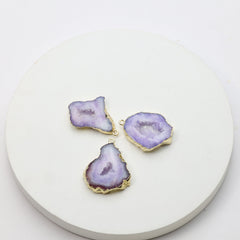 Purple geode slice pendants with sparkling druzy centers and gold connector loops