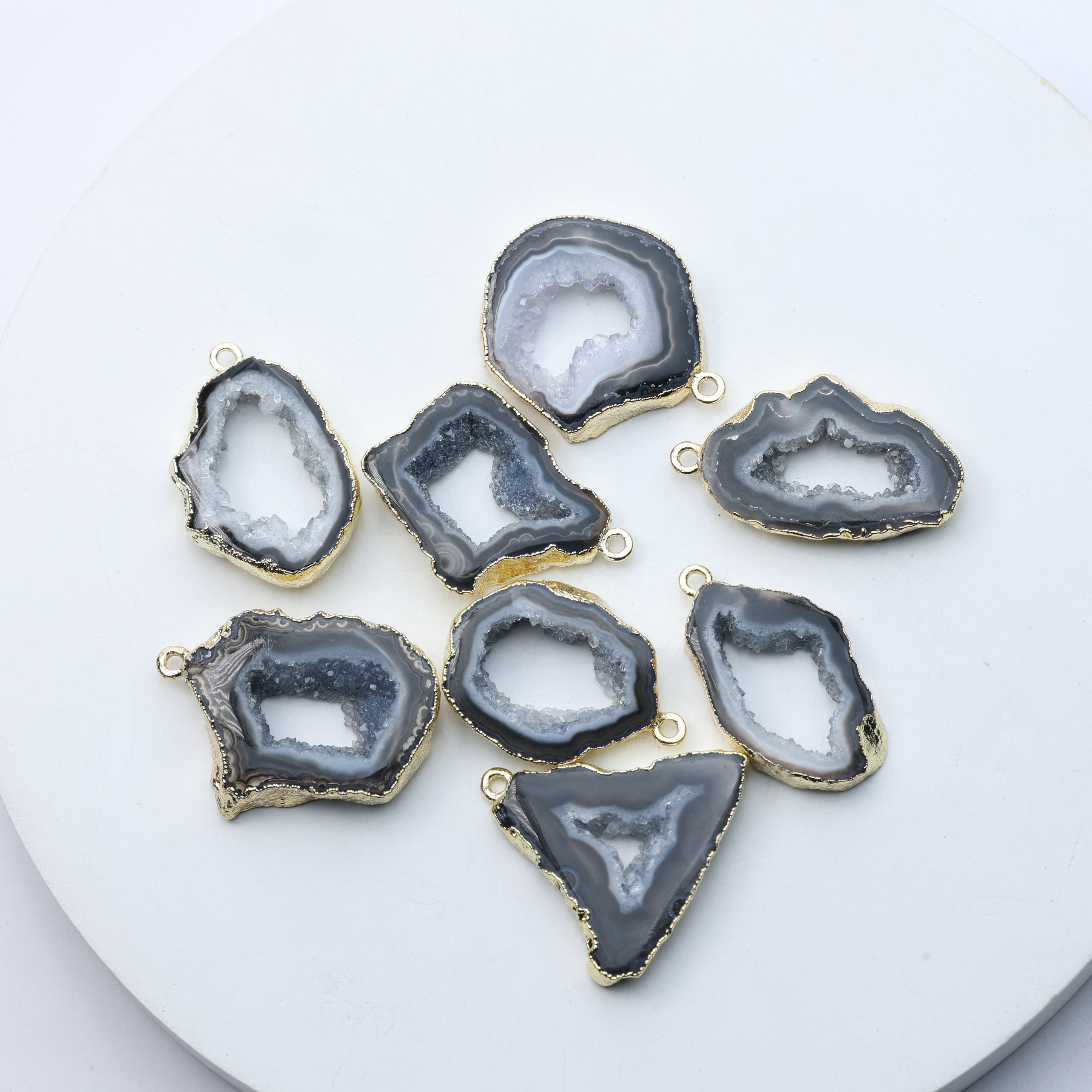 Grey agate geode druzy charms with gold-plated rims for DIY jewelry.