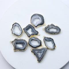 Grey agate geode druzy charms with gold-plated rims for DIY jewelry.