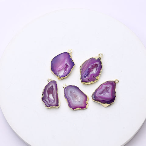 Long purple druzy geode slice pendants bordered by gold plating