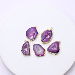 Long purple druzy geode slice pendants bordered by gold plating