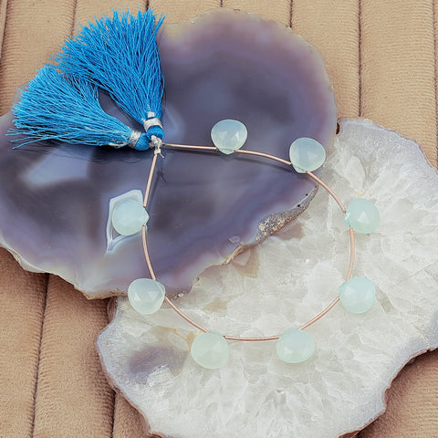Hand-cut blue briolette beads arranged on wire strand