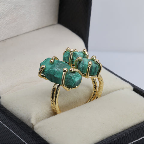 Raw crystal statement ring with gold plating and multicolor gemstones.