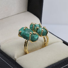 Raw crystal statement ring with gold plating and multicolor gemstones.