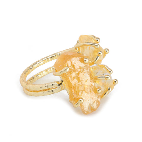 Designer gold-plated ring with natural rough gemstones in a triple-stone setting.