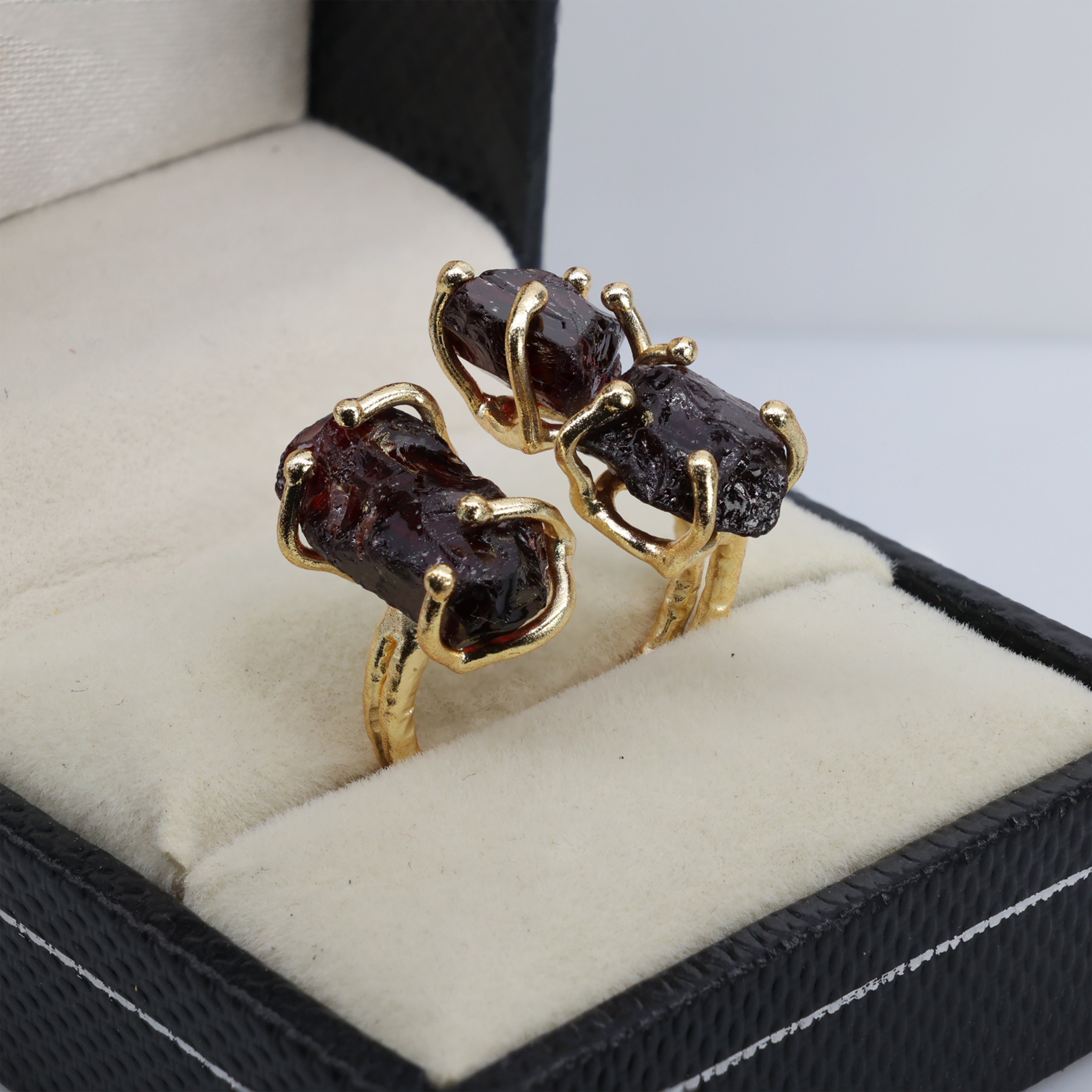 Chunky gold ring with unpolished amethyst and mixed raw gemstones.